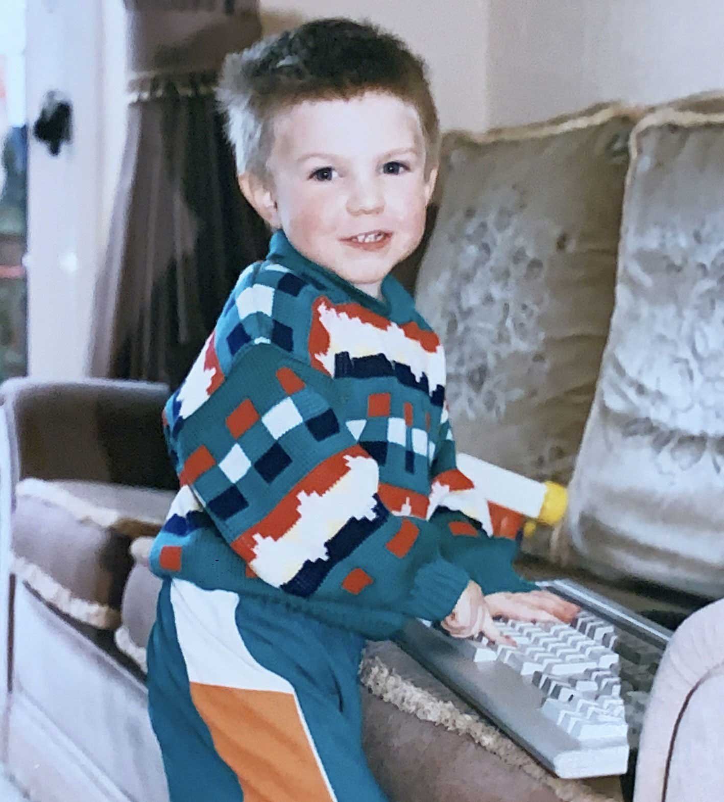 A photo of baby Dave using a computer